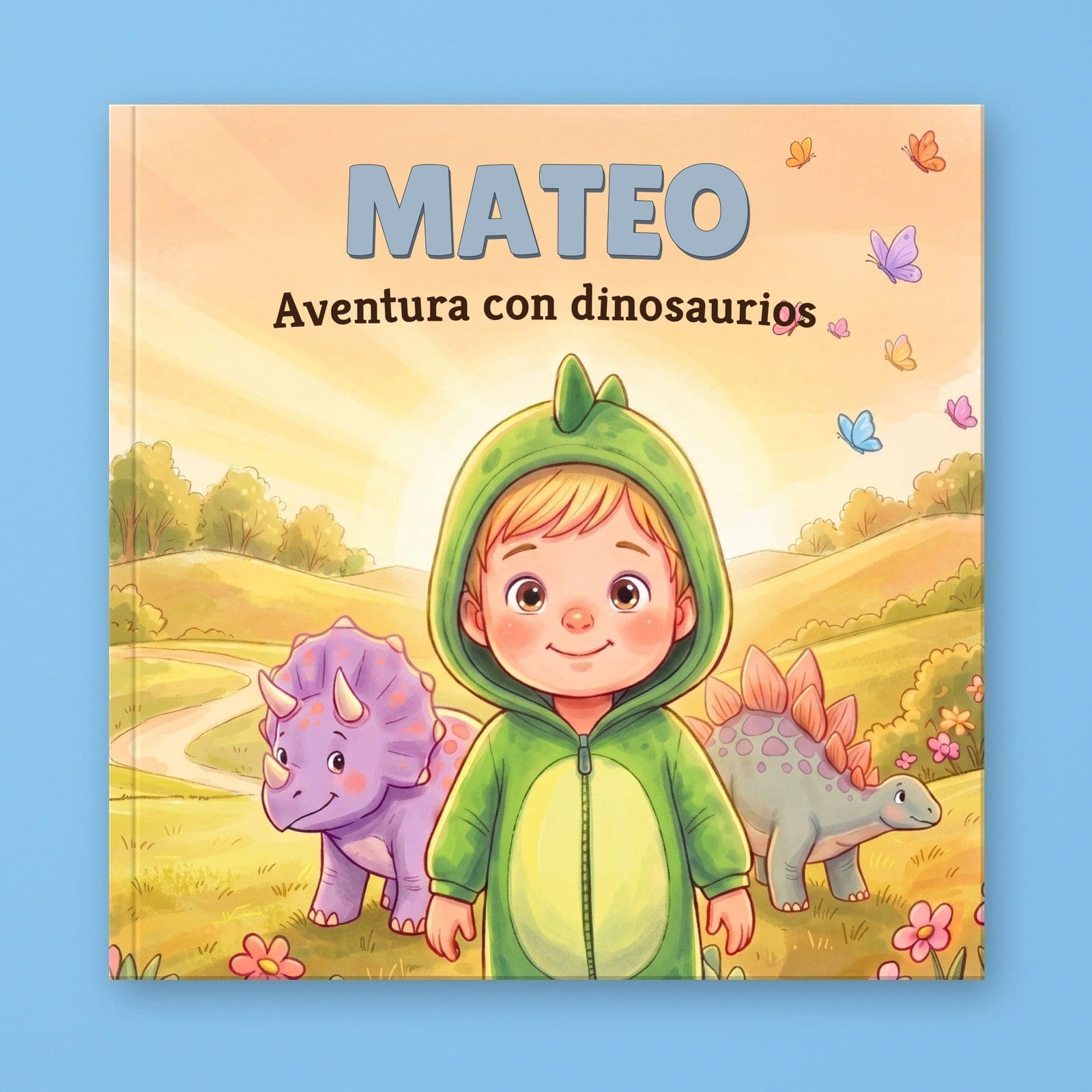 Mateo's Dinosaur Adventure, un libro ilustrado cuadrado con el niño de ejemplo en un mono verde de dinosaurio entre un bebé Triceratops y un Estegosaurio.